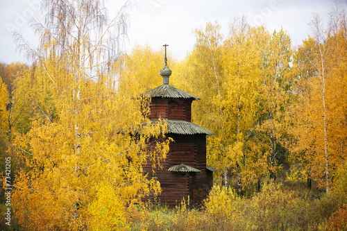 Autumn landscape with a wooden church in Kostroma, Russia. photo