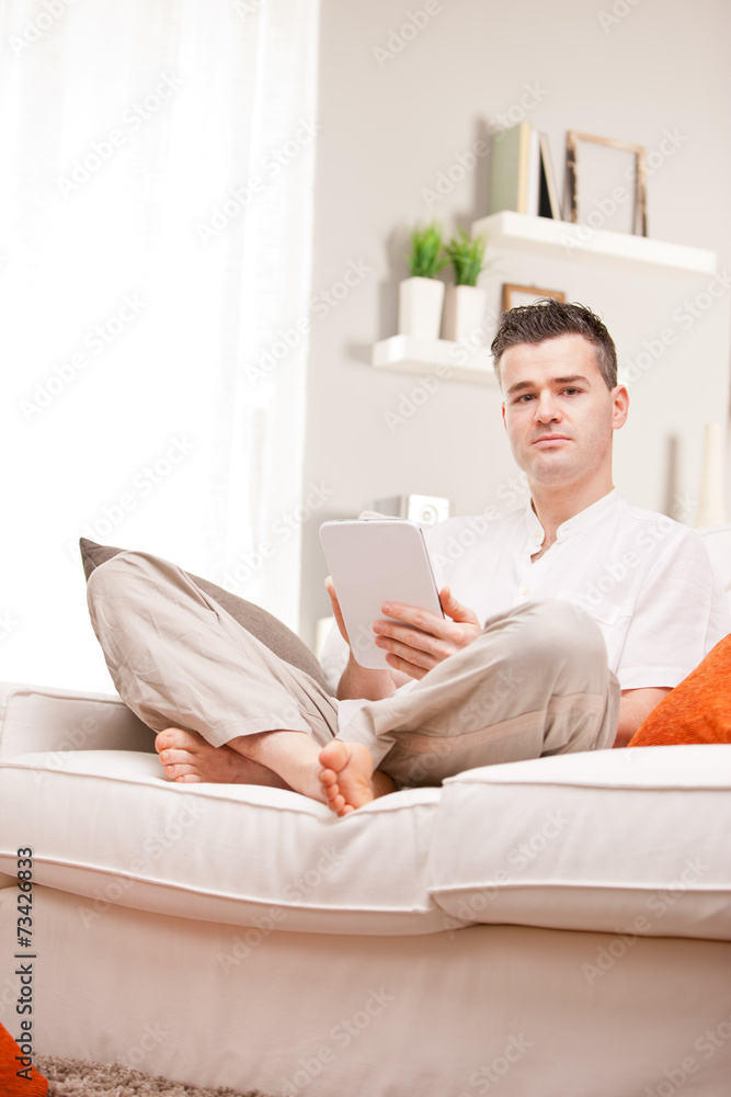 relaxed man using a tablet at home relaxed man using a tablet at home