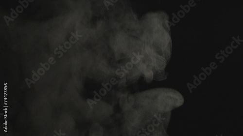 Real white steam isolated on black background with visible
