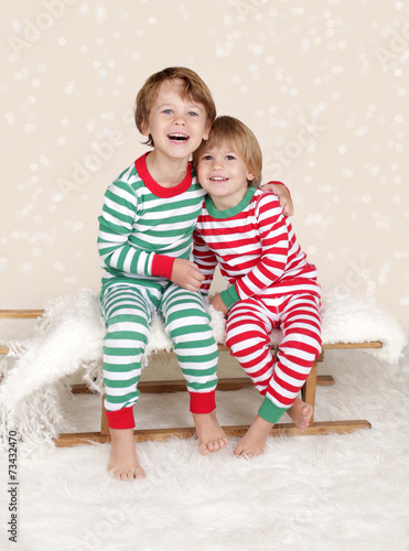 Winter Holidays: Laughing Happy Kids in Christmas Pajamas Sled i