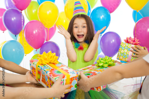 Photography Joyful little kid girl receiving gifts at birthday party