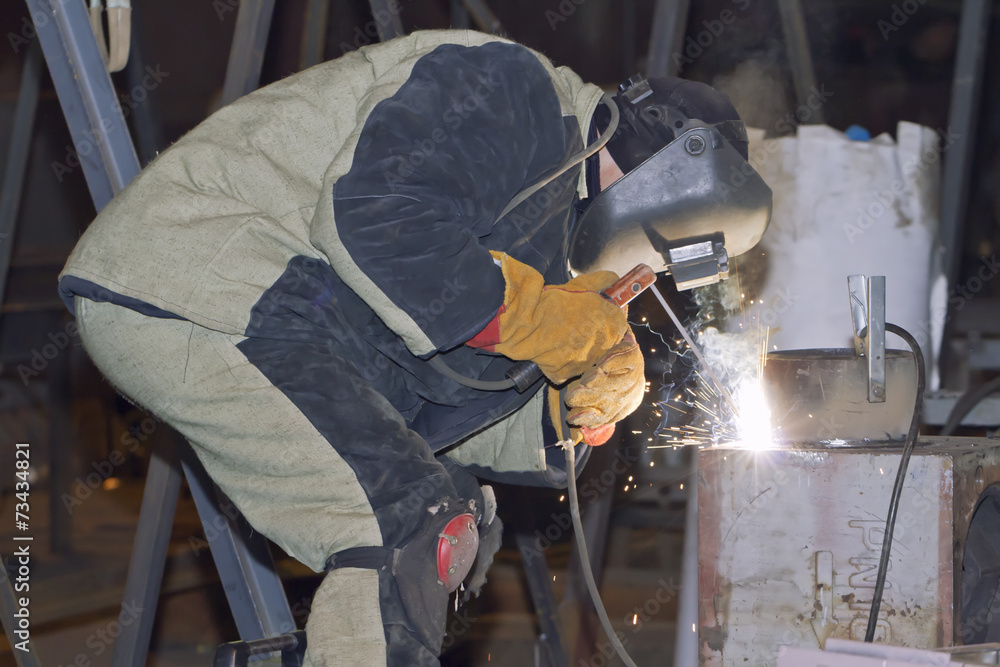 Welder working on welding of shells heat exchanger Welder working on welding of shells heat exchanger