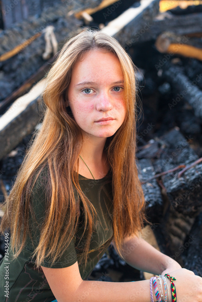 Young girl near the coals from the conflagration. Young girl near the coals from the conflagration.