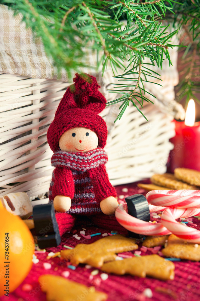 Decorative wooden doll on christmas background. Close-up.