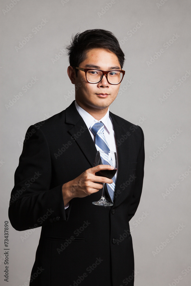 Asian businessman with glass of red wine Asian businessman with glass of red wine