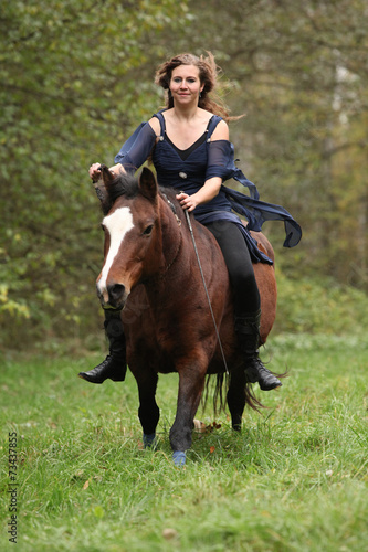 Amazing girl with horse running without bridle and saddle