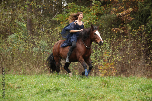 Amazing girl with horse running without bridle and saddle