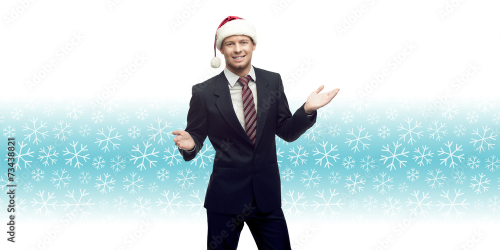 young business man in santa hat showing empty space over winter young business man in santa hat showing empty space over winter