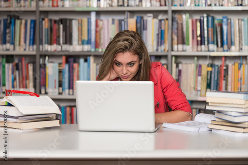 Close-Up Of Happy Student Working On Laptop