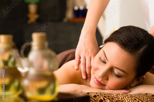 Chinese Woman at wellness massage with essential oils