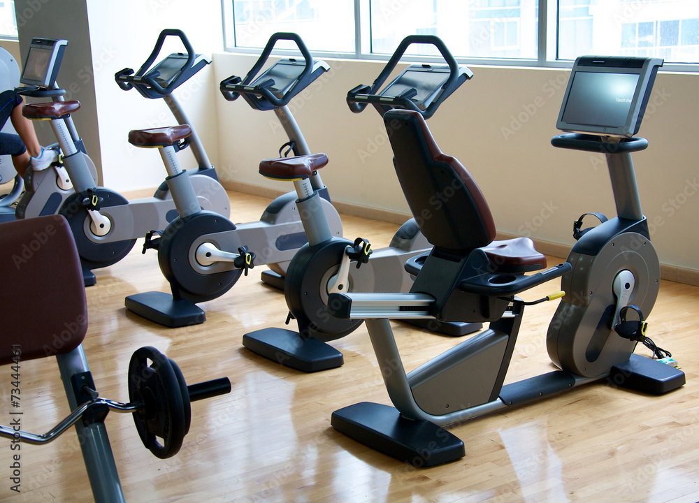 Naklejka premium A row of exercise bikes in upscale gym