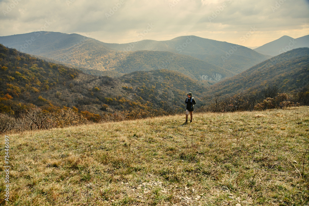 Woman walking in autumn mountains