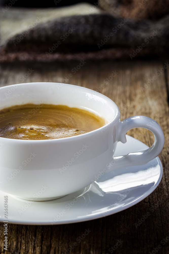 Composition with white cup of coffee on wooden table Composition with white cup of coffee on wooden table