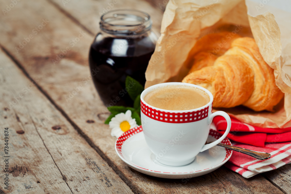 Breakfast setting: cup of coffee, croissants and strawberries Breakfast setting: cup of coffee, croissants and strawberries