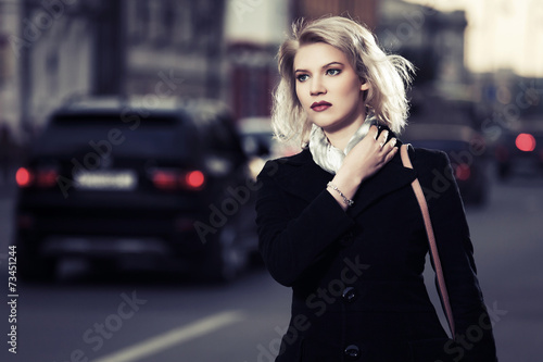 Young fashion woman walking on the city street