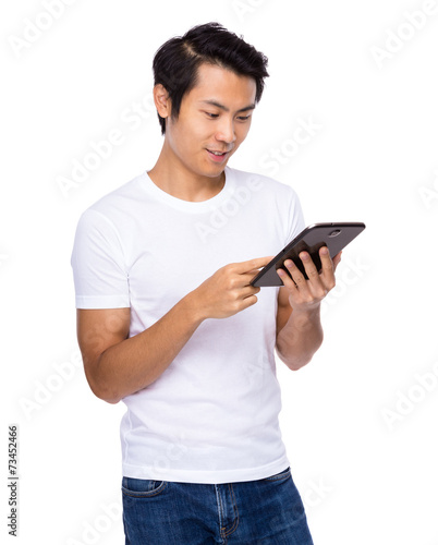 Asian man look at tablet