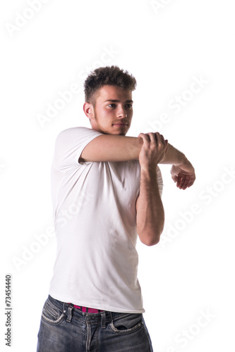 Handsome young man or teenager stretching arm and shoulder