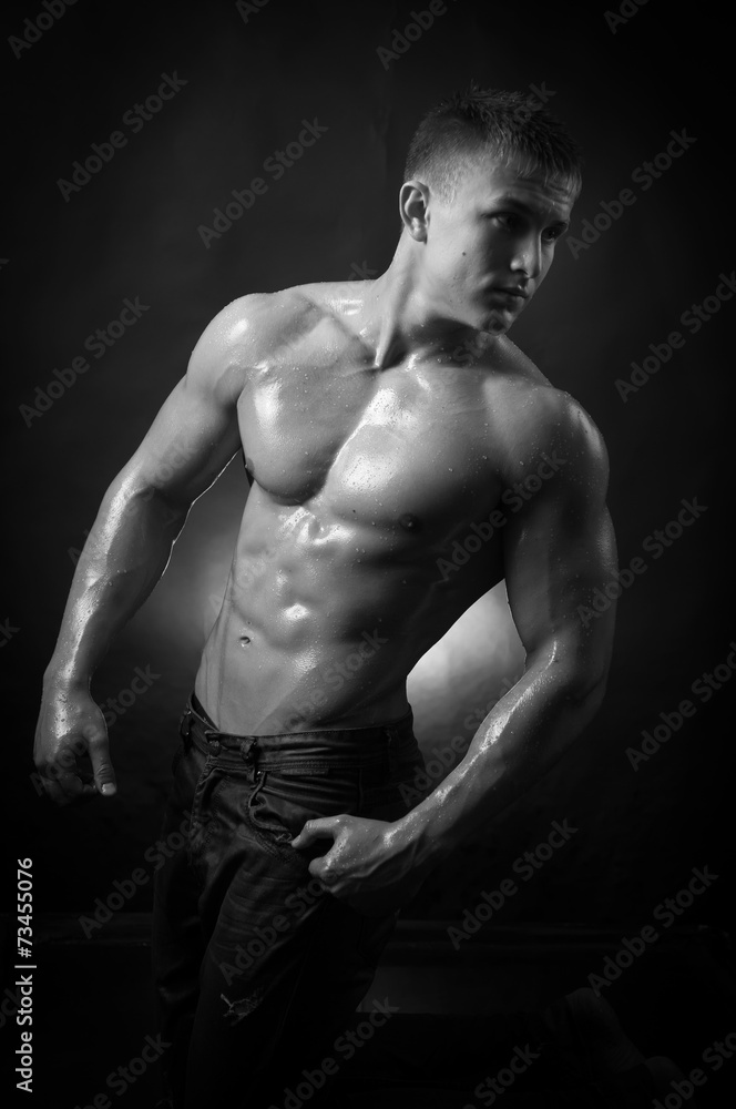 Muscular man covered with water drops Muscular man covered with water drops