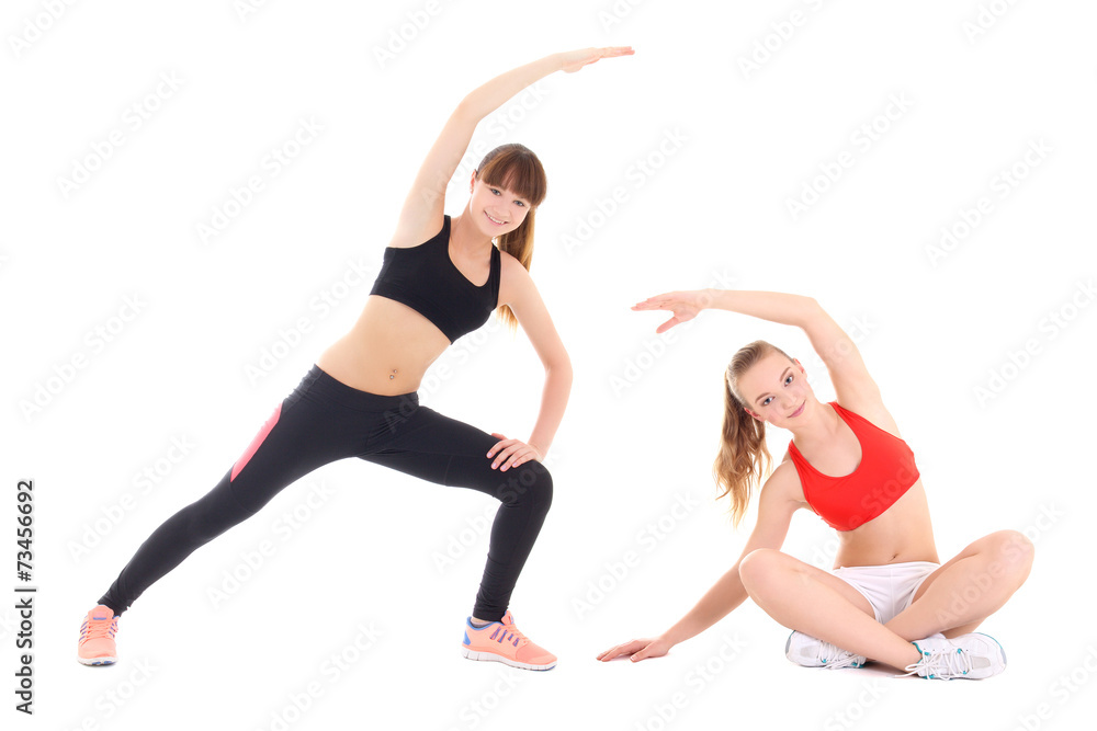 two young sporty women doing stretching exercise over white back