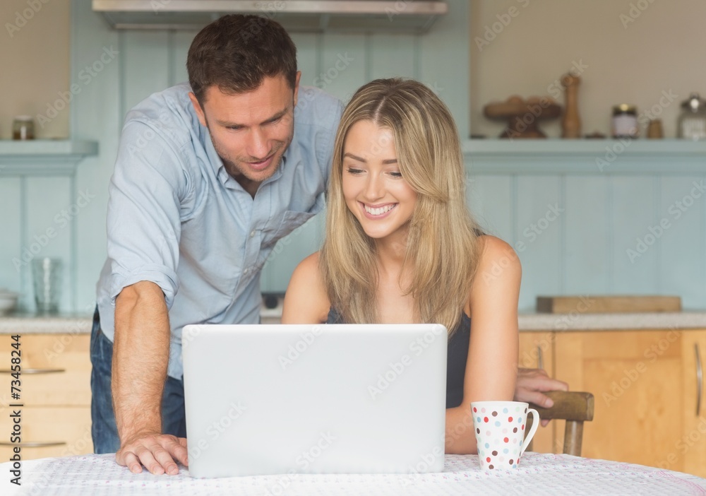 Cute couple using laptop together Cute couple using laptop together