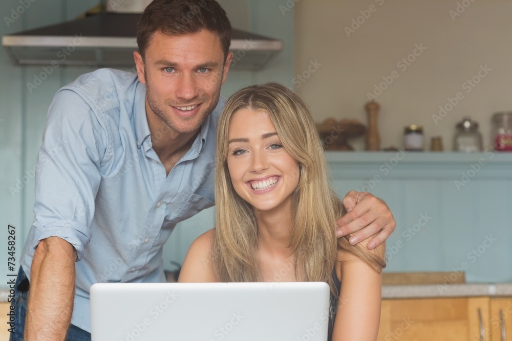 Cute couple using laptop together Cute couple using laptop together