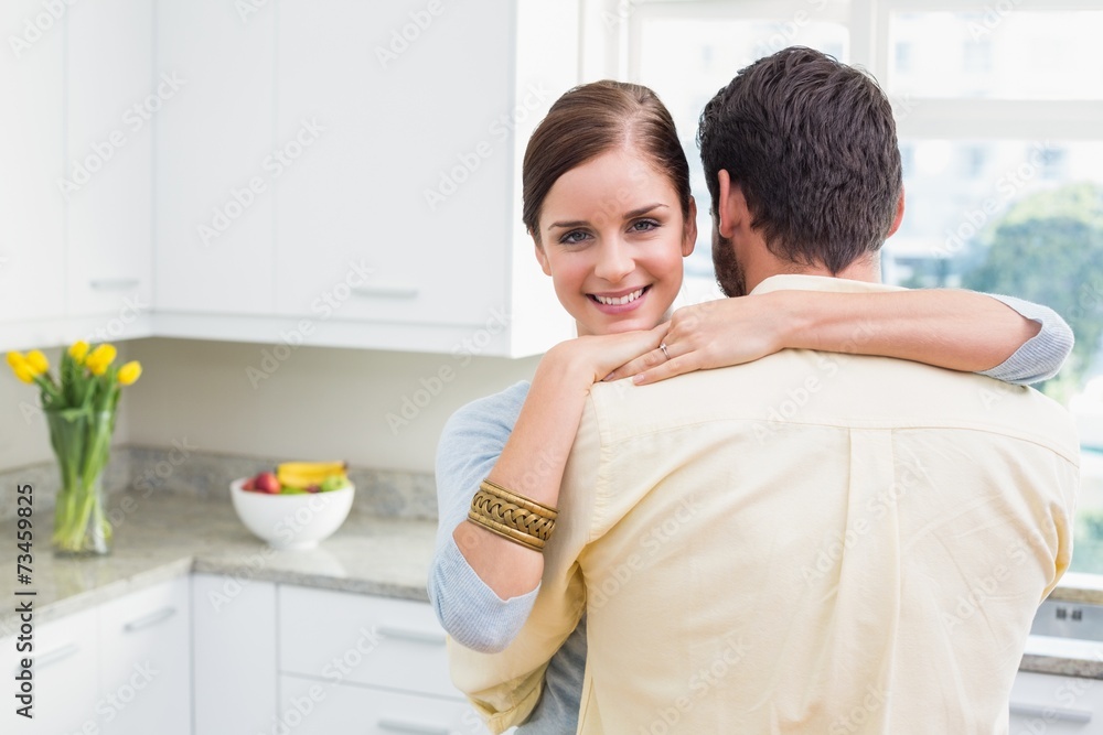 Young couple hugging with woman smiling at camera Young couple hugging with woman smiling at camera