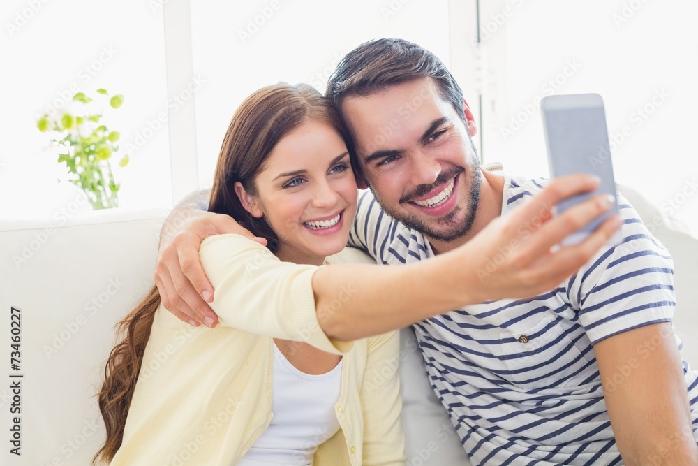 Cute couple taking a selfie on couch Cute couple taking a selfie on couch