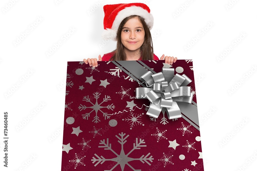 Composite image of festive little girl showing card Composite image of festive little girl showing card