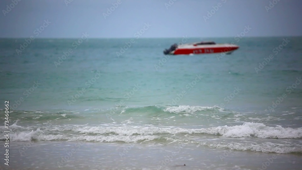 Red boat on a beach. Sea waves during cloudy weather and woman Red boat on a beach. Sea waves during cloudy weather and woman
