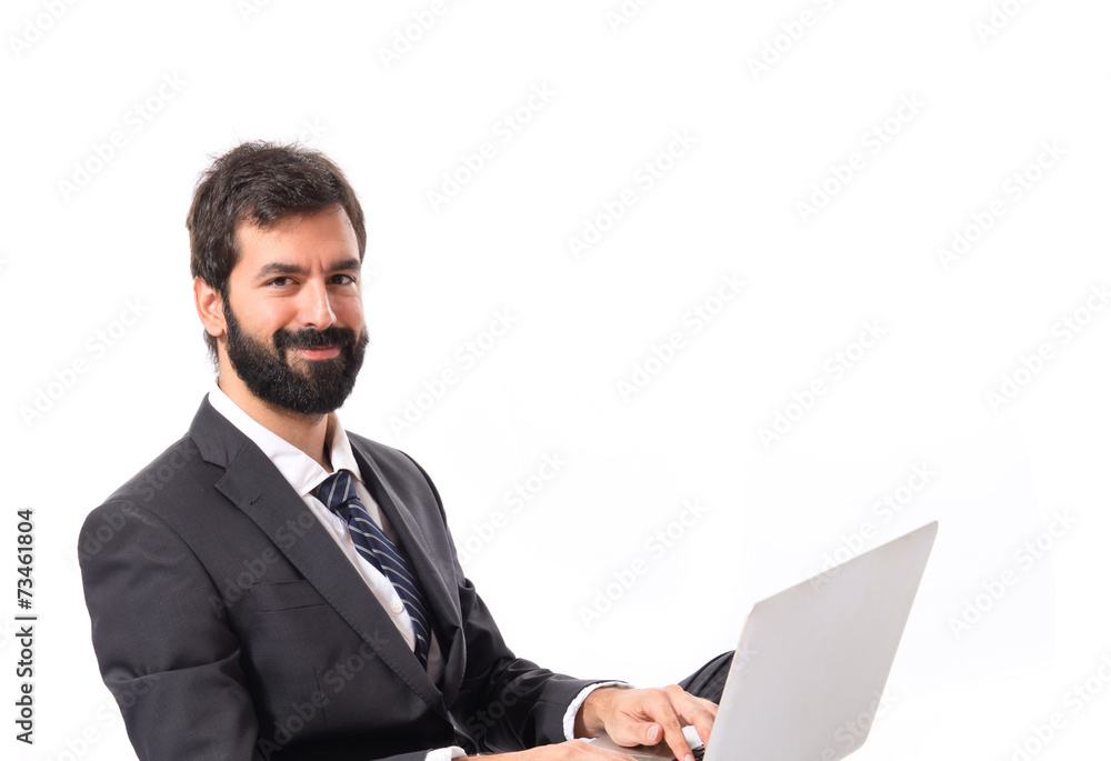 Happy businessman with laptop over isolated white background