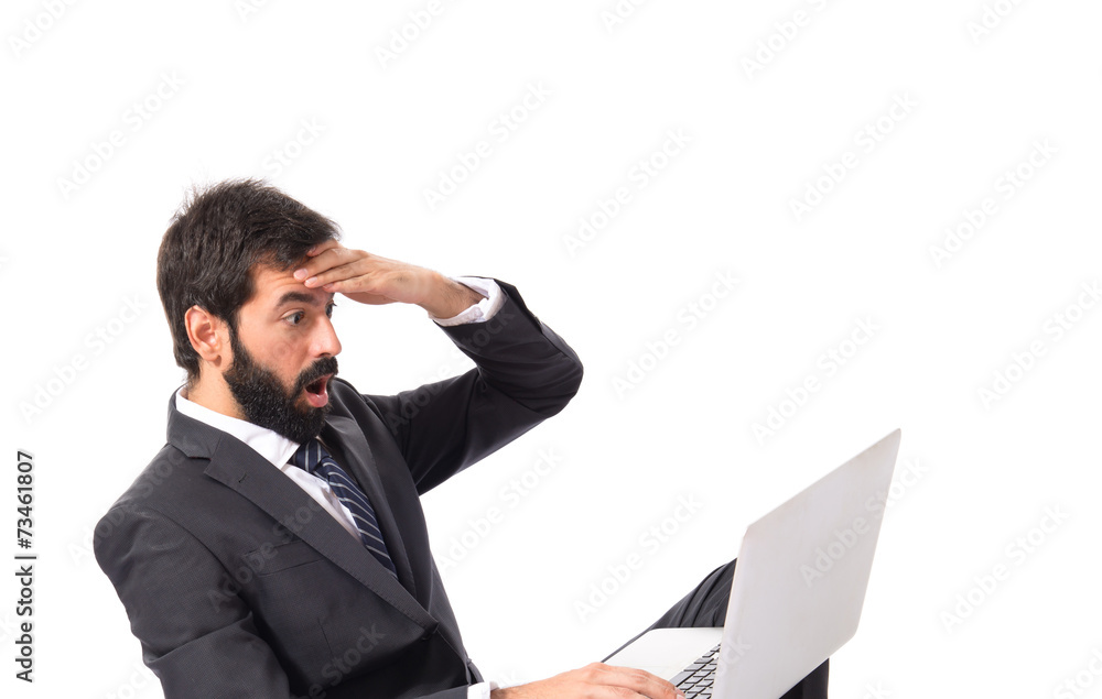 Surprised businessman with laptop over white background Surprised businessman with laptop over white background