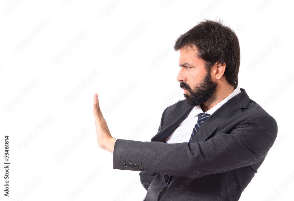 Businessman making stop sign over white background Businessman making stop sign over white background
