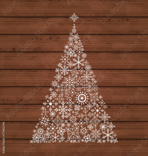 Christmas pine made of snowflakes on wooden background