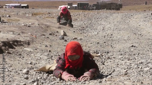 Tibetan pilgrims stretches during kora around Mapam Yumco lake. photo