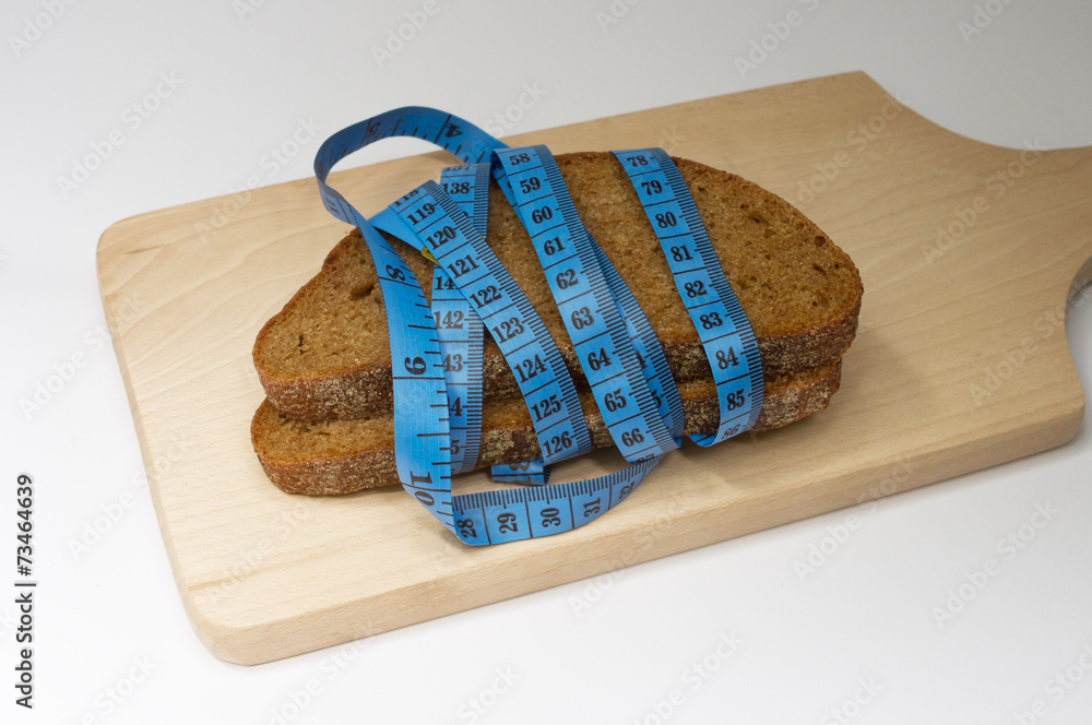 Two pieces of dark bread and meter on the board