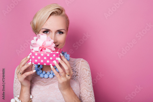 Happy birthday. Blonde woman holding small gift box with ribbon photo