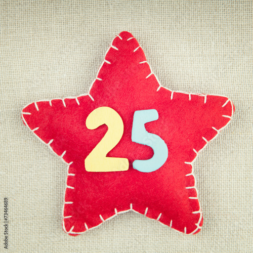 Concept for christmas, red star with wooden numbers 25 on vintag