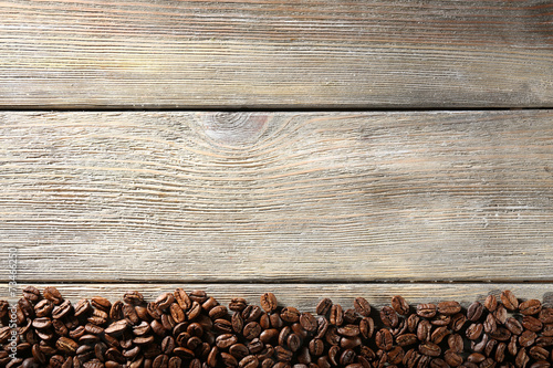 Coffee beans on wooden background © Africa Studio