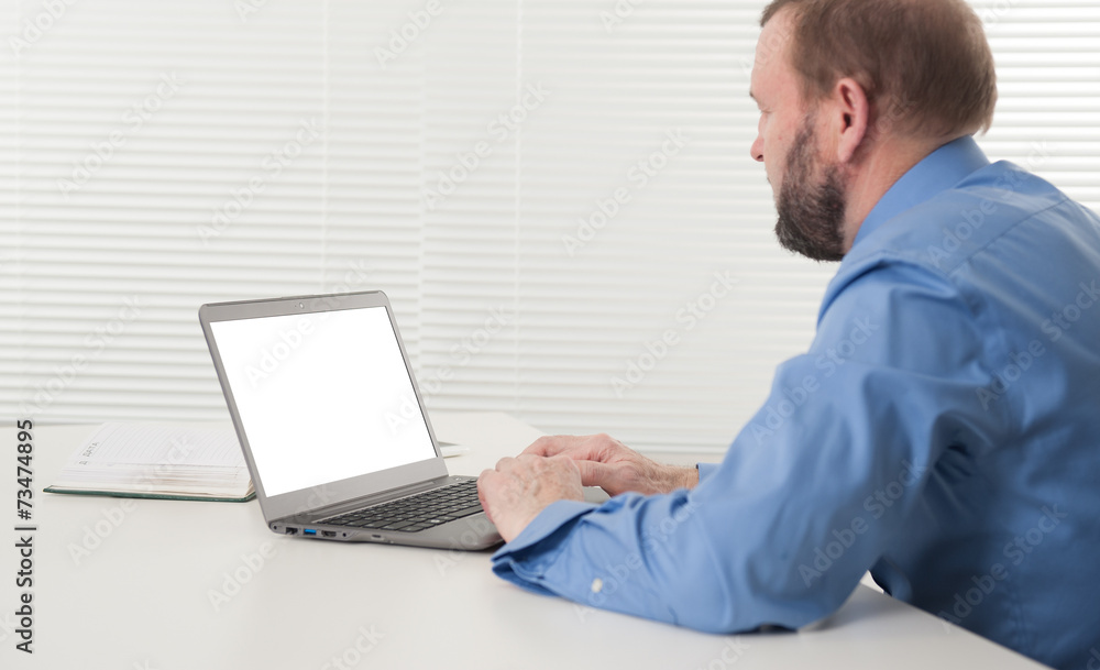 mature businessman working on his laptop mature businessman working on his laptop