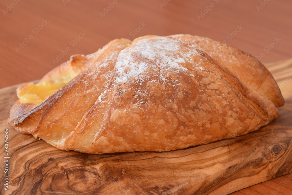 Fresh baked croissant with vanilla filling