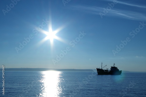 silhouette of a fishing boat photo