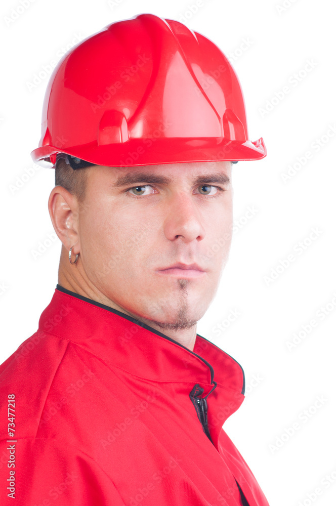 Young handsome mechanic with hard hat and tools and in overalls