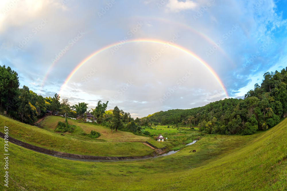 Naklejka premium Rainbow over the hill