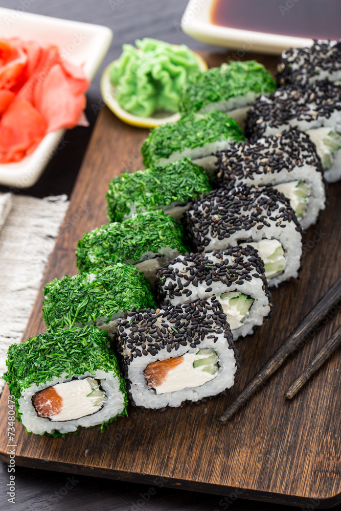 Sushi roll covered with dill and sesame Sushi roll covered with dill and sesame