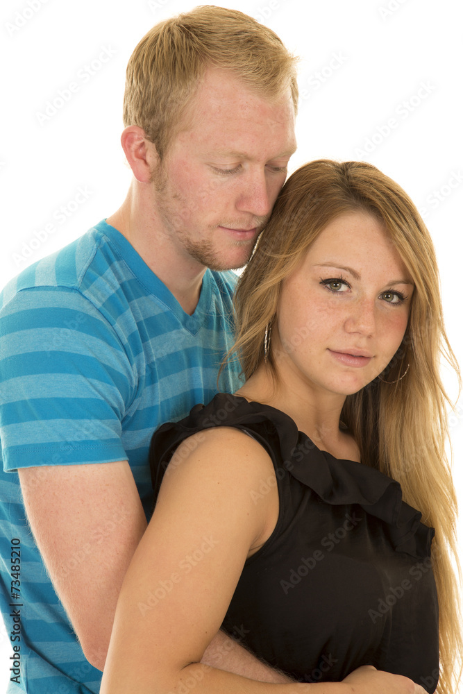 couple man blue shirt arms around woman look at her couple man blue shirt arms around woman look at her