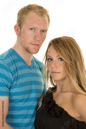 man blue shirt with woman black top looking