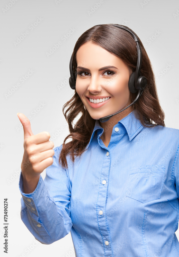 Support phone operator with thumb up gesture, on grey Support phone operator with thumb up gesture, on grey