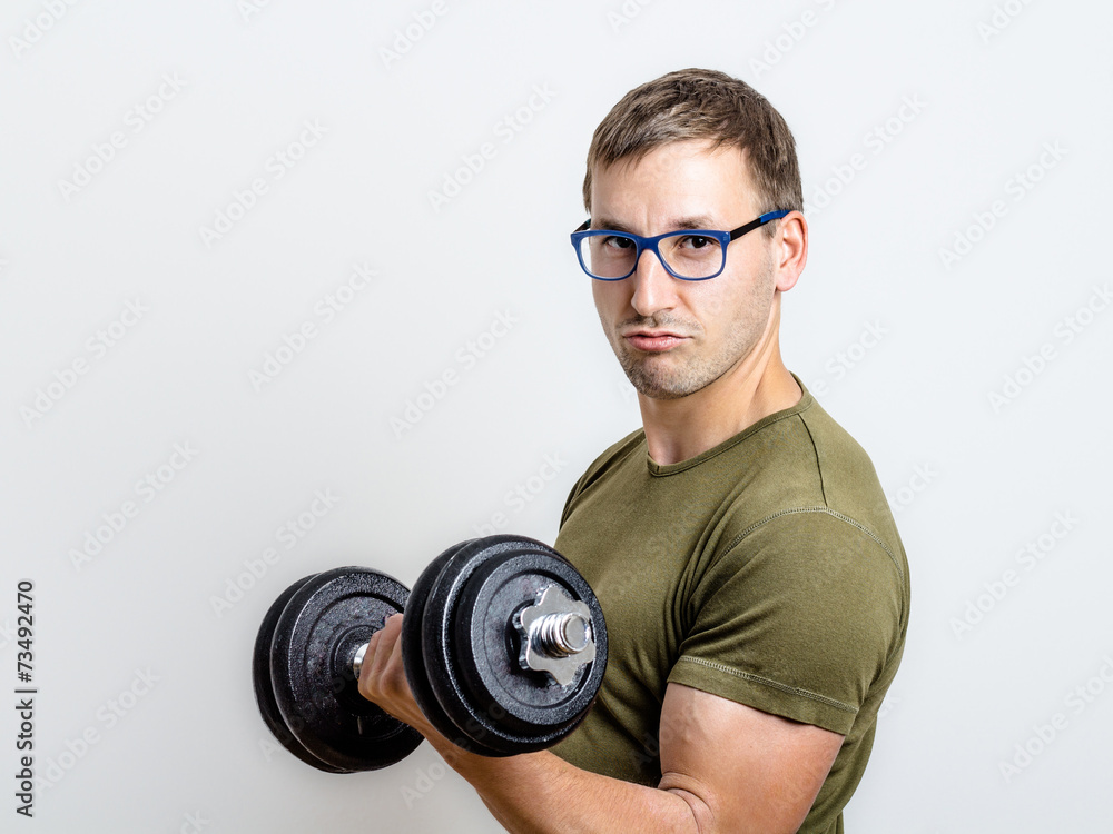 Young Man Trains His Arms