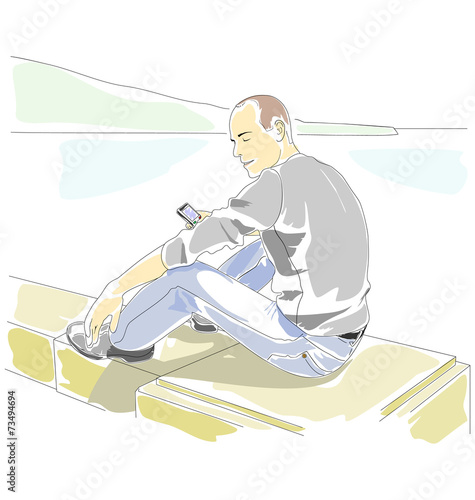 Man with mobile phone sitting on the parapet on the seaside