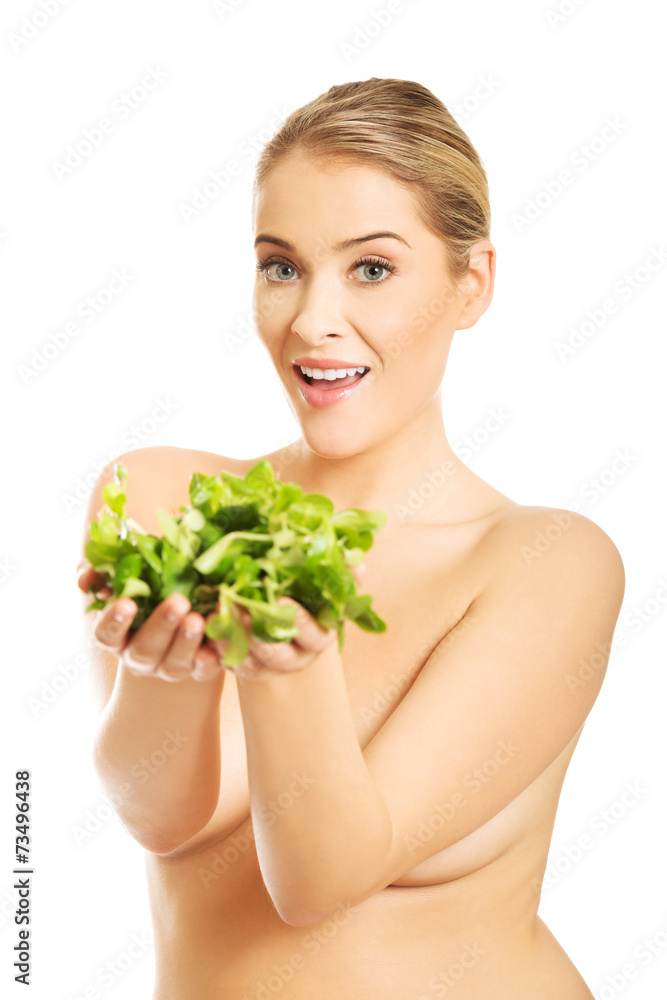 Portrait of happy nude woman giving lettuce Portrait of happy nude woman giving lettuce